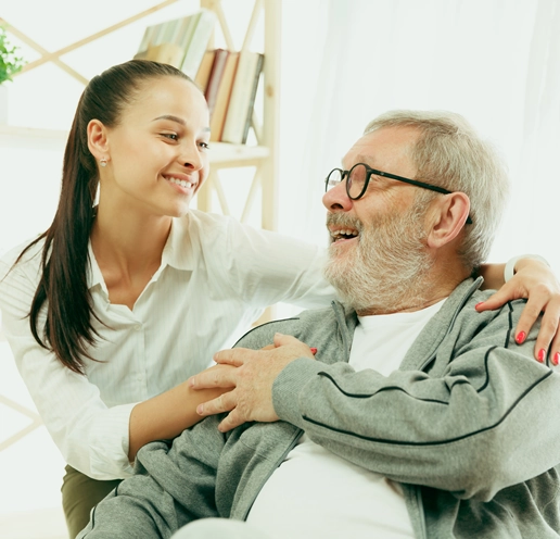 A personal support worker sharing a laugh with an older man