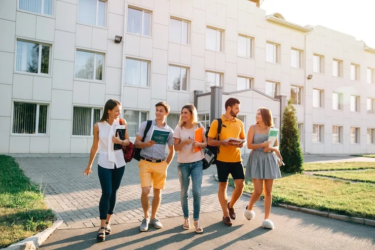 A group of students walking together outside a campus building