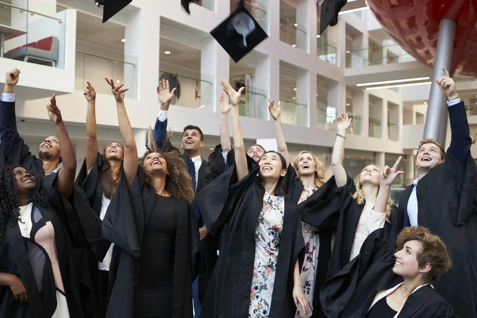 Graduates throwing their caps in the air on graduation day